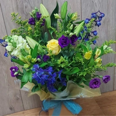 Sunshine and Blue - Stunning handtied bouquet in yellow and blue/purple flowers. carefully arranged in a gift box.

(Please note this item is only available in our local delivery area. See our delivery page for more information).

£40.00 - Grand (As shown in image)