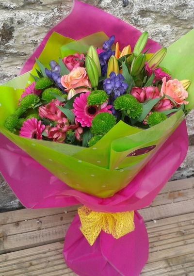 Florist Choice Handtie - Carefully selected mixed bouquet of long lasting flowers including Chrysanthemums, lily and carnations. Available in different colour combinations. (Inc Lily)