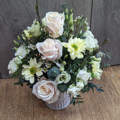 Dawn - This beautiful design featuring a blend of soft creams and pastel shades is packed full of favourite flowers. Delivered in a stylish container, this inspiration from nature is a flower gift perfect for any occasion. Ideal to be placed on a table centre, this aragnment is ready to enjoy form the moment of delivery and just needs to be topped up with water every 2 days to keep it looking beautiful. Ideal for anyone who loves flowers but doesnt wnat to arrnge them in a vase themselves. 

As with all our flowers, each design is unique and created by our in house florist and Flower box owner Tanith, Images are for inspiration purposes, your design will be carefully created just for your loved one and will be different from the photo shown. 

This design is made in floral foam within the container if your looking for an enviromentally friendly design please see our eco friendly section