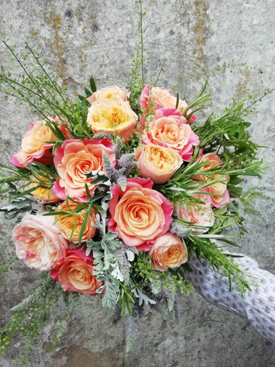 Roses in the garden - A posy style hand tied bouquet of classic flowers and foliage.