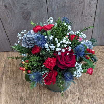 Joyfull Christmas Pot - Our ever popular Christmas table arrangement in a reusable zinc container. 
Carefully selected Christmas flowers including roses and beautiful blue thistles, 
A perfect gift for the Christmas table, easy to care for a long lasting.