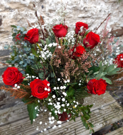 Luxury Dozen in a vase - Scented Red Naomi roses with luxury foliage and filler flowers all loving presented in a gift vase.