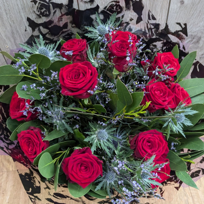 Luxury red roses Handtie - Scented Red Naomi roses with luxury foliage and filler flowers and eryngium thistles, lovingly handtied, ready to place in your loved ones favourite vase.